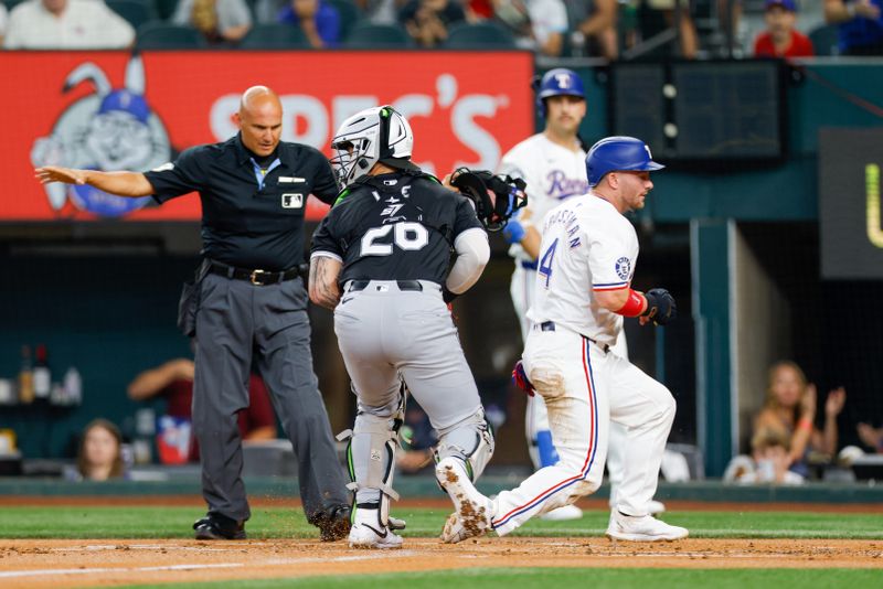 Jul 23, 2024; Arlington, Texas, USA; Texas Rangers outfielder Robbie Grossman (4) slides in under the tag of Chicago White Sox catcher Korey Lee (26) during the first inning at Globe Life Field. Mandatory Credit: Andrew Dieb-USA TODAY Sports