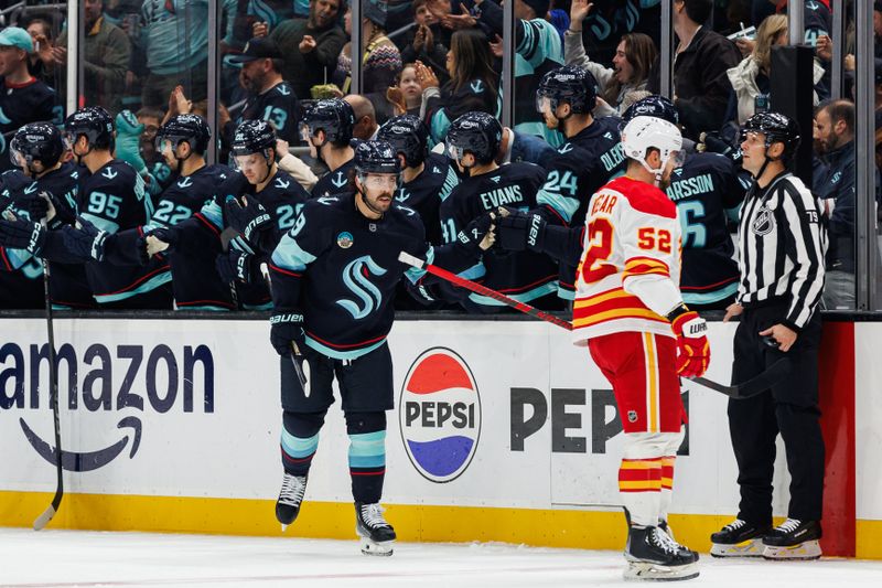 Oct 19, 2024; Seattle, Washington, USA; Seattle Kraken center Chandler Stephenson (9) celebrates with teammates after scoring a goal against the Calgary Flames during the second period at Climate Pledge Arena. Mandatory Credit: Caean Couto-Imagn Images