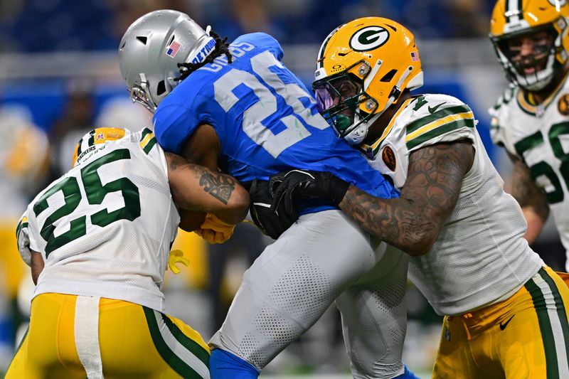 Detroit Lions running back Jahmyr Gibbs is tackle day Green Bay Packers linebacker Quay Walker and cornerback Keisean Nixon during the second half of an NFL football game, Thursday, Nov. 23, 2023, in Detroit. The Packers won 29-22. (AP Photo/David Dermer)