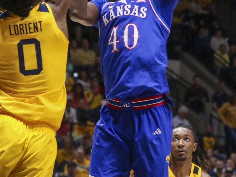 Jan 10, 2026; Morgantown, West Virginia, USA; Kansas Jayhawks forward Flory Bidunga (40) shoots over West Virginia Mountaineers forward Brenen Lorient (0) during the first half at Hope Coliseum. Mandatory Credit: Ben Queen-Imagn Images