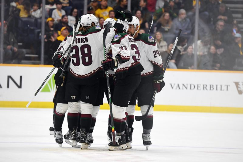 Feb 10, 2024; Nashville, Tennessee, USA; Arizona Coyotes players celebrate after a goal by defenseman Travis Dermott (33) during the first period against the Nashville Predators at Bridgestone Arena. Mandatory Credit: Christopher Hanewinckel-USA TODAY Sports