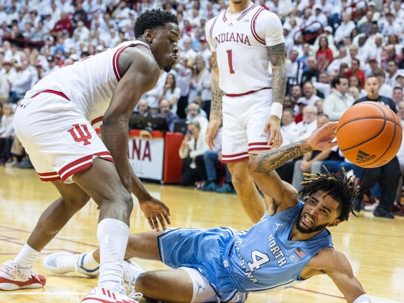 Nov 30, 2022; Bloomington, Indiana, USA; North Carolina Tar Heels guard R.J. Davis (4) looses the ball while Indiana Hoosiers guard Xavier Johnson (0) defends in the second half  at Simon Skjodt Assembly Hall. Mandatory Credit: Trevor Ruszkowski-USA TODAY Sports