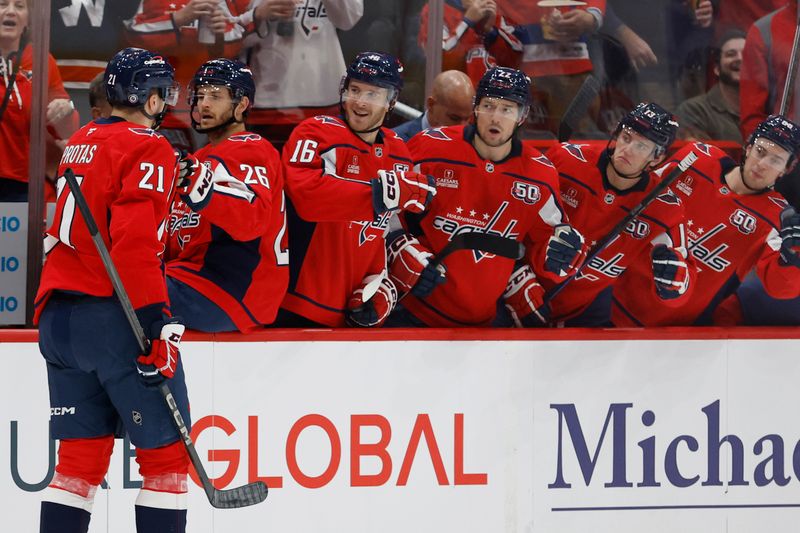 Nov 2, 2024; Washington, District of Columbia, USA; Washington Capitals center Aliaksei Protas (21) celebrates with teammates after scoring a goal against the Columbus Blue Jackets in the first period at Capital One Arena. Mandatory Credit: Geoff Burke-Imagn Images