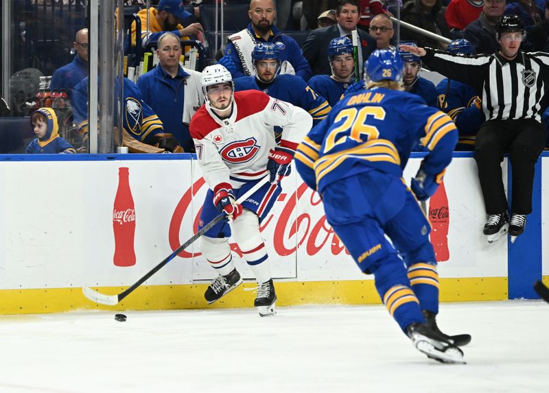 Nov 11, 2024; Buffalo, New York, USA; Montreal Canadiens center Kirby Dach (77) looks to pass the puck with Buffalo Sabres defenseman Rasmus Dahlin (26) defending in the first period at KeyBank Center. Mandatory Credit: Mark Konezny-Imagn Images