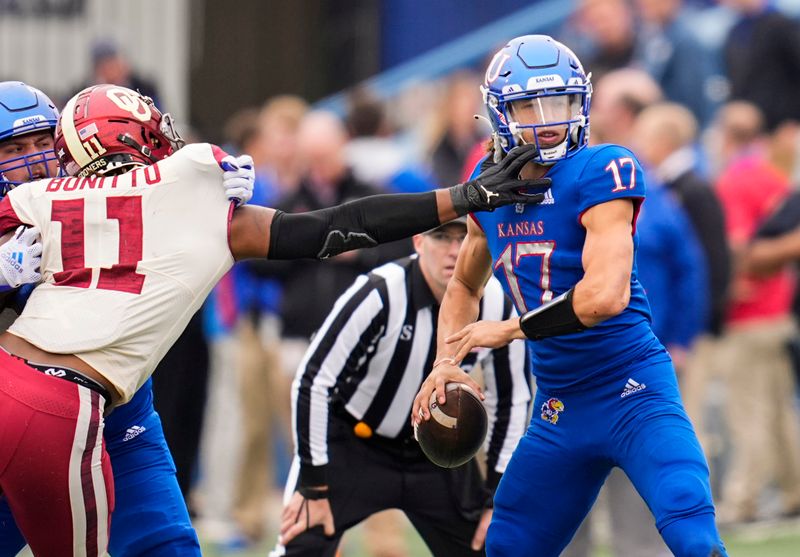 Oct 23, 2021; Lawrence, Kansas, USA; Kansas Jayhawks quarterback Jason Bean (17) drops back to pass as Oklahoma Sooners linebacker Nik Bonitto (11) defends during the second half at David Booth Kansas Memorial Stadium. Mandatory Credit: Jay Biggerstaff-USA TODAY Sports