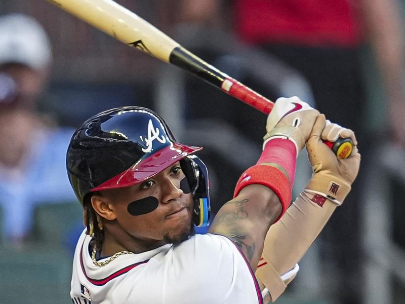 Apr 23, 2024; Cumberland, Georgia, USA; Atlanta Braves outfielder Ronald Acuna Jr. (13) doubles against the Miami Marlins during the first inning at Truist Park. Mandatory Credit: Dale Zanine-USA TODAY Sports