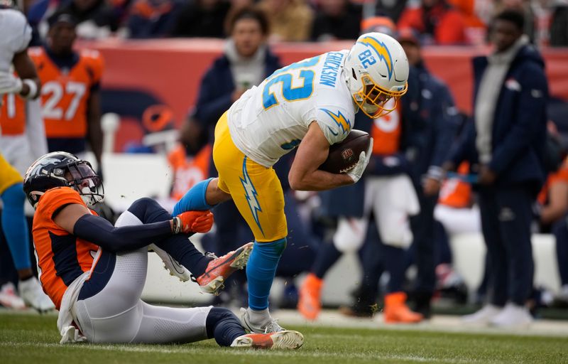 Denver Broncos safety Justin Simmons (31) stops Los Angeles Chargers wide receiver Alex Erickson (82) in the first half of an NFL football game in Empower Field at Mile High Sunday, Dec. 31, 2023, in Denver. (AP Photo/David Zalubowski)