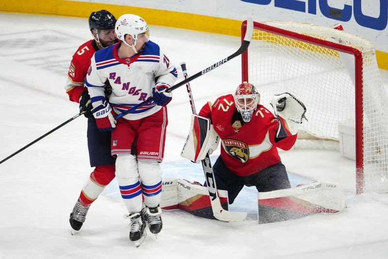 Dec 29, 2023; Sunrise, Florida, USA; Florida Panthers goaltender Sergei Bobrovsky (72) blocks a shot behind New York Rangers left wing Chris Kreider (20) and defenseman Aaron Ekblad (5) during the third period at Amerant Bank Arena. Mandatory Credit: Jasen Vinlove-USA TODAY Sports