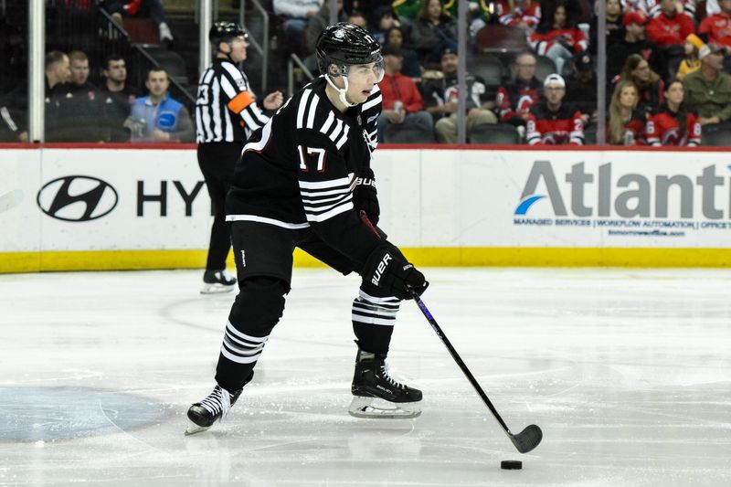 Apr 7, 2024; Newark, New Jersey, USA; New Jersey Devils defenseman Simon Nemec (17) skates with the puck during the third period against the Nashville Predators at Prudential Center. Mandatory Credit: John Jones-USA TODAY Sports