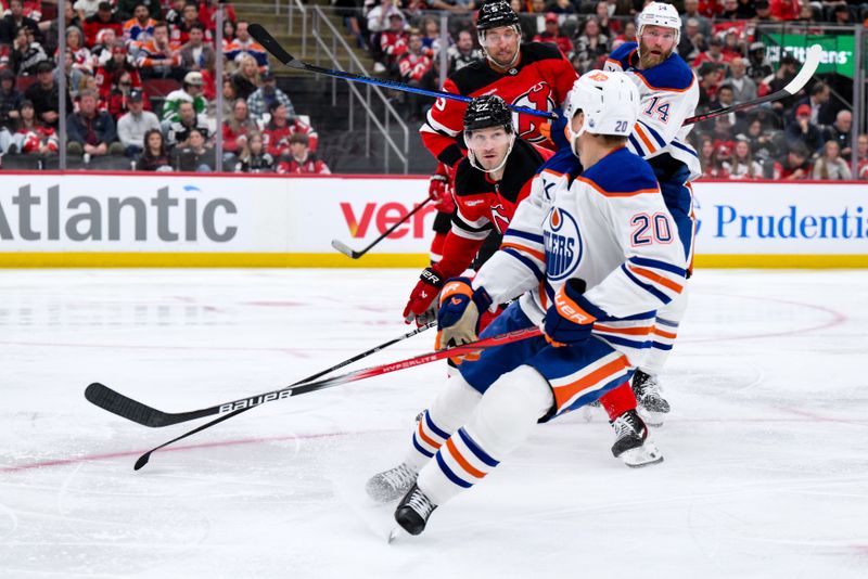 Oct 18, 2025; Newark, New Jersey, USA; Edmonton Oilers center Curtis Lazar (20) skates against New Jersey Devils defenseman Brett Pesce (22) during the third period at Prudential Center. Mandatory Credit: John Jones-Imagn Images
