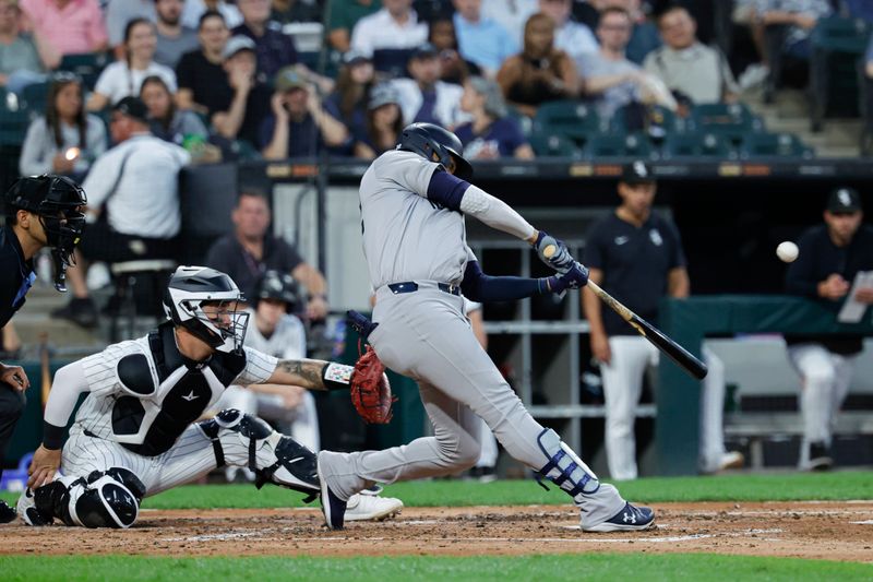Aug 13, 2024; Chicago, Illinois, USA; New York Yankees outfielder Juan Soto (22) hits a two-run home run against the Chicago White Sox during the third inning at Guaranteed Rate Field. Mandatory Credit: Kamil Krzaczynski-USA TODAY Sports
