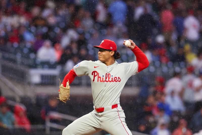 Apr 10, 2025; Atlanta, Georgia, USA; Philadelphia Phillies starting pitcher Jesus Luzardo (44) throws in a light rain against the Atlanta Braves in the second inning at Truist Park. Mandatory Credit: Brett Davis-Imagn Images