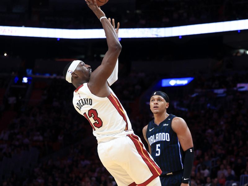 MIAMI, FLORIDA - OCTOBER 23: Bam Adebayo #13 of the Miami Heat shoots over Paolo Banchero #5 of the Orlando Magic during the second half at Kaseya Center on October 23, 2024 in Miami, Florida. NOTE TO USER: User expressly acknowledges and agrees that, by downloading and or using this photograph, User is consenting to the terms and conditions of the Getty Images License Agreement. (Photo by Carmen Mandato/Getty Images)