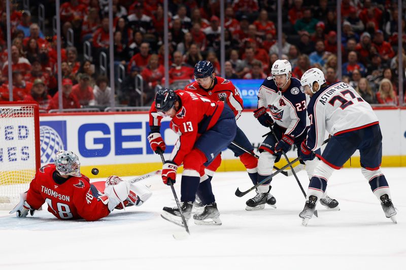 Nov 2, 2024; Washington, District of Columbia, USA; Washington Capitals goaltender Logan Thompson (48) makes a save on Columbus Blue Jackets center Zachary Aston-Reese (27) in the second period at Capital One Arena. Mandatory Credit: Geoff Burke-Imagn Images