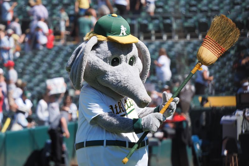 Jul 4, 2024; Oakland, California, USA; Oakland Athletics mascot, Stomper, waves a broom after a sweep of the Los Angeles Angels at Oakland-Alameda County Coliseum. Mandatory Credit: Kelley L Cox-USA TODAY Sports