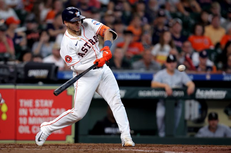 Aug 18, 2024; Houston, Texas, USA; Houston Astros catcher Yainer Diaz (21) hits a home run to left field against the Chicago White Sox during the sixth inning at Minute Maid Park. Mandatory Credit: Erik Williams-USA TODAY Sports