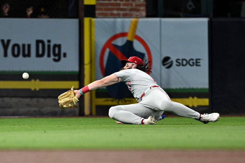 Apr 26, 2024; San Diego, California, USA; Philadelphia Phillies left fielder Brandon Marsh (16) cannot make a catch on a RBI double hit by San Diego Padres first baseman Jake Cronenworth (not pictured) during the third inning at Petco Park. Mandatory Credit: Orlando Ramirez-USA TODAY Sports