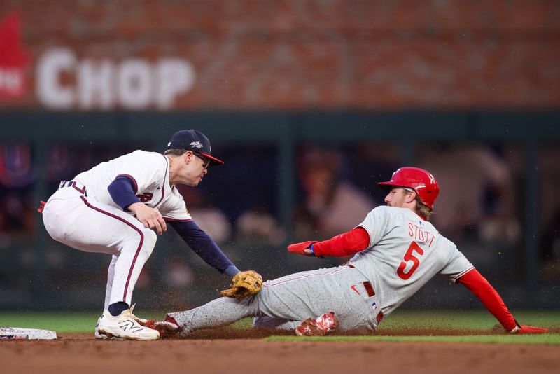 Apr 10, 2025; Atlanta, Georgia, USA; Atlanta Braves shortstop Nick Allen (2) tags out Philadelphia Phillies second baseman Bryson Stott (5) in the third inning at Truist Park. Mandatory Credit: Brett Davis-Imagn Images
