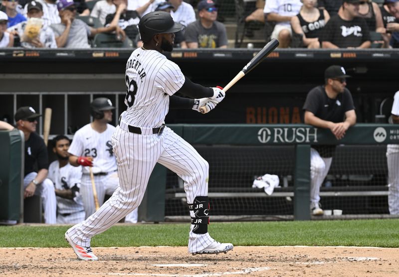 Jun 20, 2024; Chicago, Illinois, USA;  Chicago White Sox outfielder Luis Robert Jr. (88) hits an RBI double against the Houston Astros during the fifth inning at Guaranteed Rate Field. Mandatory Credit: Matt Marton-USA TODAY Sports