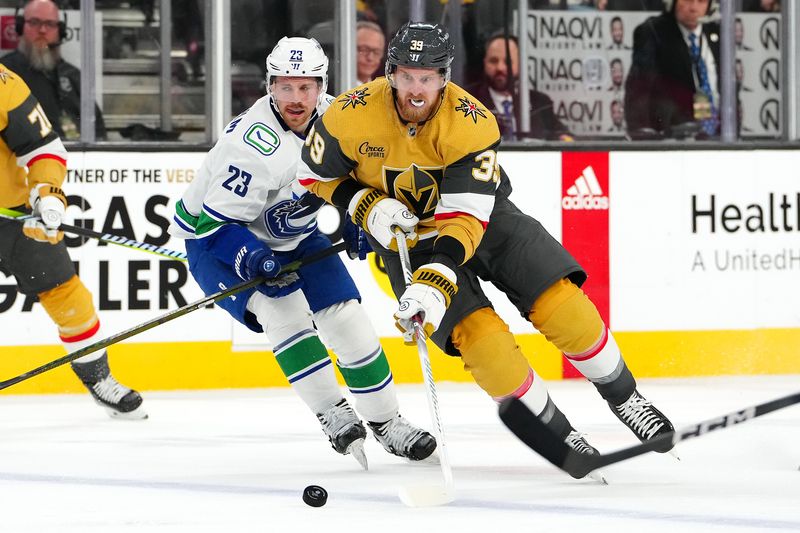 Mar 7, 2024; Las Vegas, Nevada, USA; Vegas Golden Knights right wing Anthony Mantha (39) carries the puck ahead of Vancouver Canucks center Elias Lindholm (23) during the second period at T-Mobile Arena. Mandatory Credit: Stephen R. Sylvanie-USA TODAY Sports