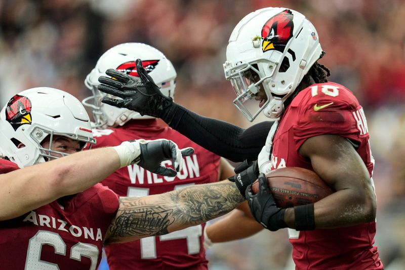 Arizona Cardinals wide receiver Marvin Harrison Jr. (18) celebrates his touchdown catch against the Los Angeles Rams during the first half of an NFL football game, Sunday, Sept. 15, 2024, in Glendale, Ariz. (AP Photo/Ross D. Franklin)