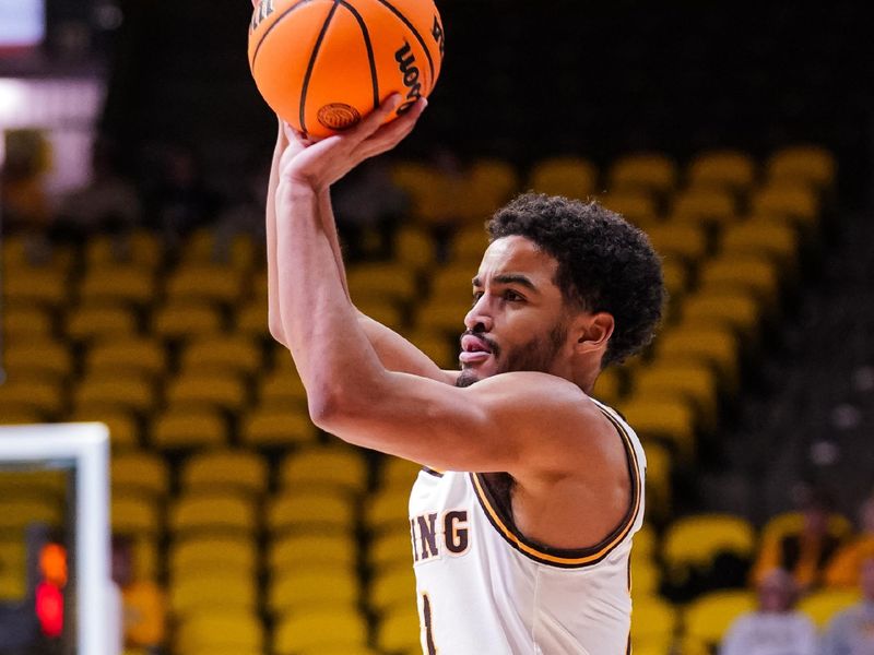 Jan 31, 2023; Laramie, Wyoming, USA; Wyoming Cowboys guard Noah Reynolds (21) shoots against the Fresno State Bulldogs during the first half at Arena-Auditorium. Mandatory Credit: Troy Babbitt-USA TODAY Sports