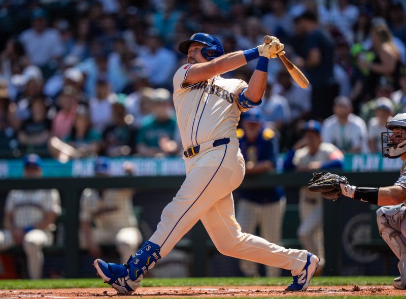 Aug 24, 2025; Seattle, Washington, USA; Seattle Mariners catcher Cal Raleigh (29) hits a two-run home run during the first inning against the Athletics at T-Mobile Park. Mandatory Credit: Stephen Brashear-Imagn Images