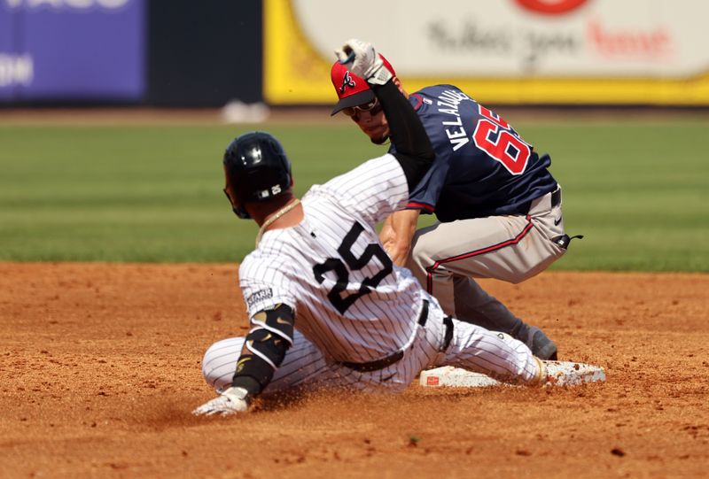 Mar 10, 2024; Tampa, Florida, USA; New York Yankees second baseman Gleyber Torres (25) slides safe into seocnd base as Atlanta Braves infielder Andrew Velazquez (65)  attempted to tag him out during the third inning at George M. Steinbrenner Field. Mandatory Credit: Kim Klement Neitzel-USA TODAY Sports