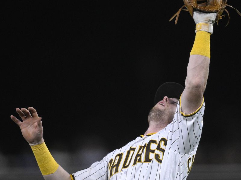 Aug 21, 2023; San Diego, California, USA; San Diego Padres first baseman Jake Cronenworth (9) catches a pop-up hit by Miami Marlins designated hitter Jorge Soler (not pictured) during the seventh inning at Petco Park. Mandatory Credit: Orlando Ramirez-USA TODAY Sports