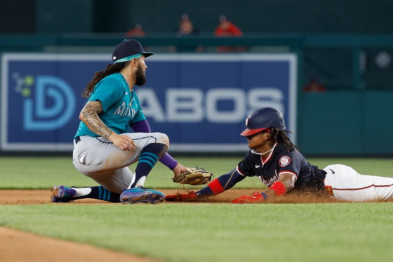 May 24, 2024; Washington, District of Columbia, USA; Washington Nationals shortstop CJ Abrams (5) is tagged out by Seattle Mariners shortstop J.P. Crawford (3) attempting to steal second base during the seventh inning at Nationals Park. Mandatory Credit: Geoff Burke-USA TODAY Sports