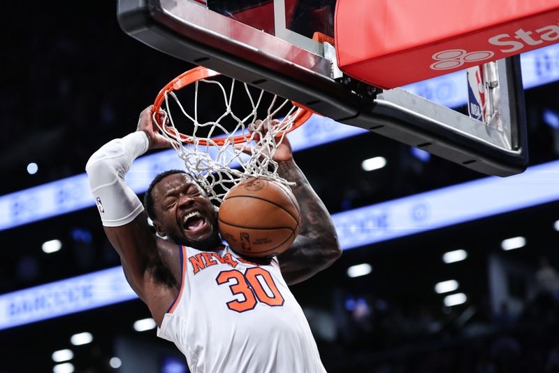 NEW YORK, NEW YORK - JANUARY 23: Julius Randle #30 of the New York Knicks dunks the ball during the fourth quarter of the game against the Brooklyn Nets at Barclays Center on January 23, 2024 in New York City.  NOTE TO USER: User expressly acknowledges and agrees that, by downloading and or using this photograph, User is consenting to the terms and conditions of the Getty Images License Agreement. (Photo by Dustin Satloff/Getty Images)