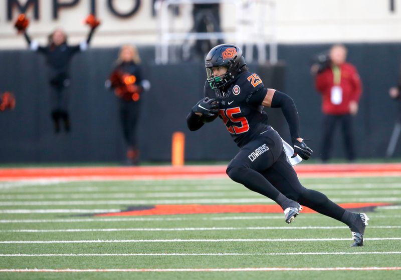 Nov 12, 2022; Stillwater, Oklahoma, USA;  Oklahoma State Cowboys safety Jason Taylor II (25) runs after an interception against the Iowa State Cyclones in the third quarter at Boone Pickens Stadium. OSU won 20-14. Mandatory Credit: Sarah Phipps-USA TODAY Sports