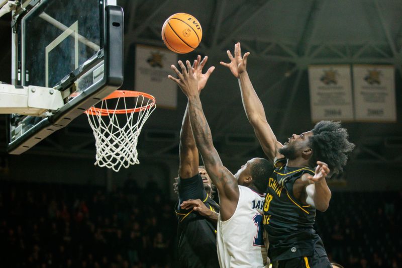 Feb 11, 2024; Wichita, Kansas, USA; Florida Atlantic Owls guard Johnell Davis (1) shoots the ball around Wichita State Shockers forward Dalen Ridgnal (10) during the second half at Charles Koch Arena. Mandatory Credit: William Purnell-USA TODAY Sports