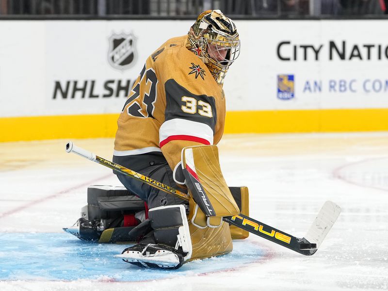 Sep 30, 2022; Las Vegas, Nevada, USA; Vegas Golden Knights goaltender Adin Hill (33) makes a stick save against the San Jose Sharks during the third period of a preseason game at T-Mobile Arena. Mandatory Credit: Stephen R. Sylvanie-USA TODAY Sports