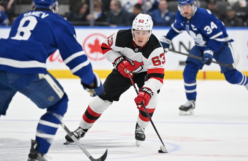 Jan 16, 2025; Toronto, Ontario, CAN;  New Jersey Devils forward Jesper Bratt (63) skates with the puck against the Toronto Maple Leafs in the second period at Scotiabank Arena. Mandatory Credit: Dan Hamilton-Imagn Images