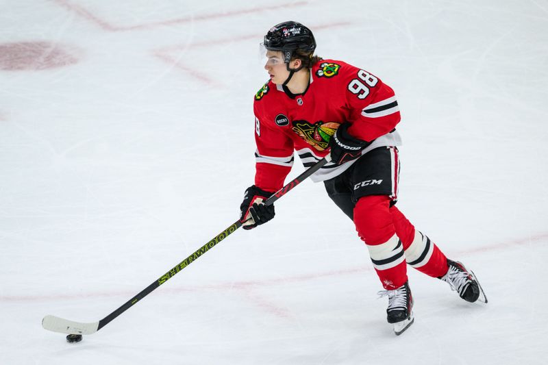 Dec 10, 2023; Chicago, Illinois, USA; Chicago Blackhawks center Connor Bedard (98) skates with the puck against the Washington Capitals during the third period at the United Center. Mandatory Credit: Daniel Bartel-USA TODAY Sports