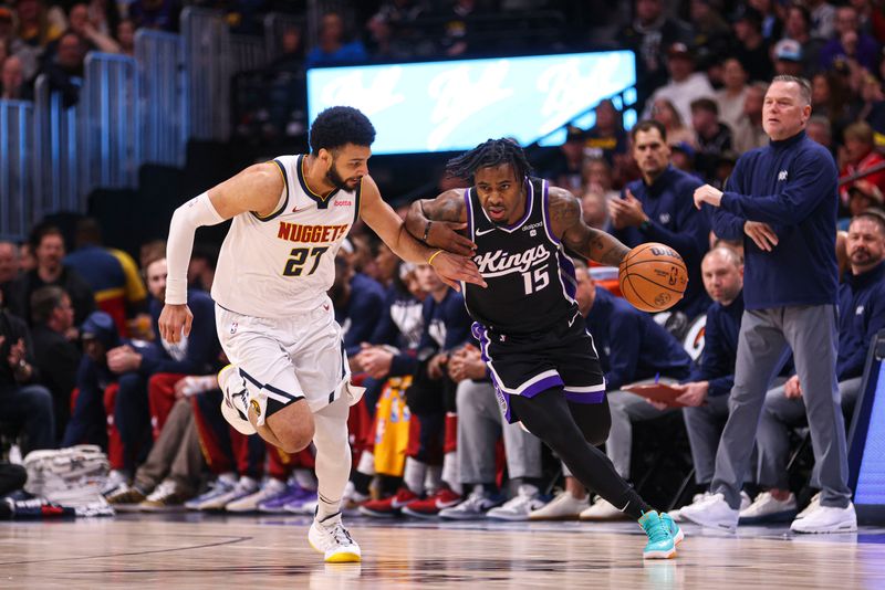 DENVER, COLORADO - FEBRUARY 28: Davion Mitchell #15 of the Sacramento Kings dribbles the ball against Jamal Murray #27 of the Denver Nuggets during the first quarter at Ball Arena on February 28, 2024 in Denver, Colorado. NOTE TO USER: User expressly acknowledges and agrees that, by downloading and or using this photograph, User is consenting to the terms and conditions of the Getty Images License Agreement. (Photo by Alysa Rubin/Clarkson Creative/Getty Images)