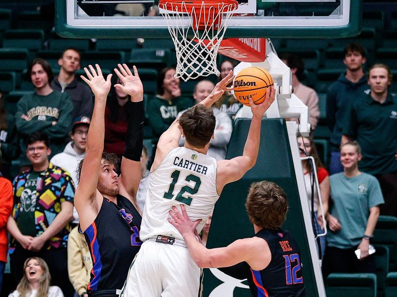 Feb 15, 2023; Fort Collins, Colorado, USA; Colorado State Rams forward Patrick Cartier (12) drives to the net against \Boise State Broncos forward Tyson Degenhart (2) and guard Max Rice (12) in the first half at Moby Arena. Mandatory Credit: Isaiah J. Downing-USA TODAY Sports