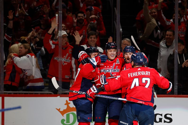 Apr 26, 2024; Washington, District of Columbia, USA;Washington Capitals defenseman John Carlson (74) celebrates with teammates after scoring a goal against the New York Rangers in the first period in game three of the first round of the 2024 Stanley Cup Playoffs at Capital One Arena. Mandatory Credit: Geoff Burke-USA TODAY Sports