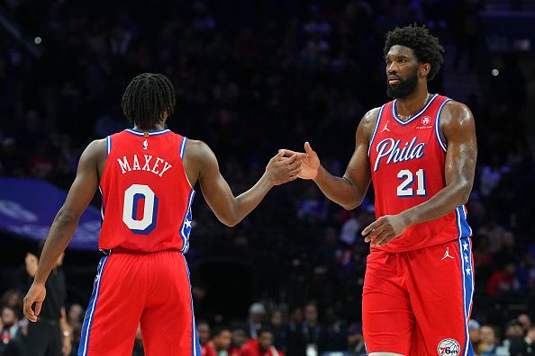 PHILADELPHIA, PENNSYLVANIA - DECEMBER 8: Tyrese Maxey #0 of the Philadelphia 76ers celebrates with Joel Embiid #21 against the Atlanta Hawks in the fourth quarter at the Wells Fargo Center on December 8, 2023 in Philadelphia, Pennsylvania. The 76ers defeated the Hawks 125-114. NOTE TO USER: User expressly acknowledges and agrees that, by downloading and or using this photograph, User is consenting to the terms and conditions of the Getty Images License Agreement. (Photo by Mitchell Leff/Getty Images)