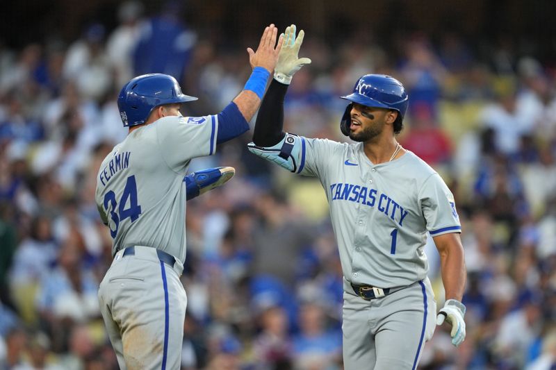 Jun 15, 2024; Los Angeles, California, USA; Kansas City Royals left fielder MJ Melendez (1) celebrates with catcher Freddy Fermin (34) after hitting a grand slam home run in the sixth inning against the Los Angeles Dodgers at Dodger Stadium. Mandatory Credit: Kirby Lee-USA TODAY Sports