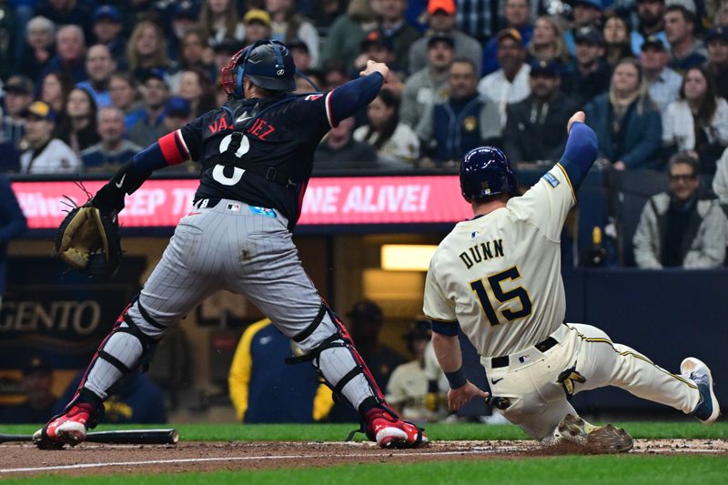 Apr 2, 2024; Milwaukee, Wisconsin, USA; Milwaukee Brewers second baseman Oliver Dunn (15) is forced out at home plate by Minnesota Twins catcher Christian Vazquez (8) in the second inning at American Family Field. Mandatory Credit: Benny Sieu-USA TODAY Sports