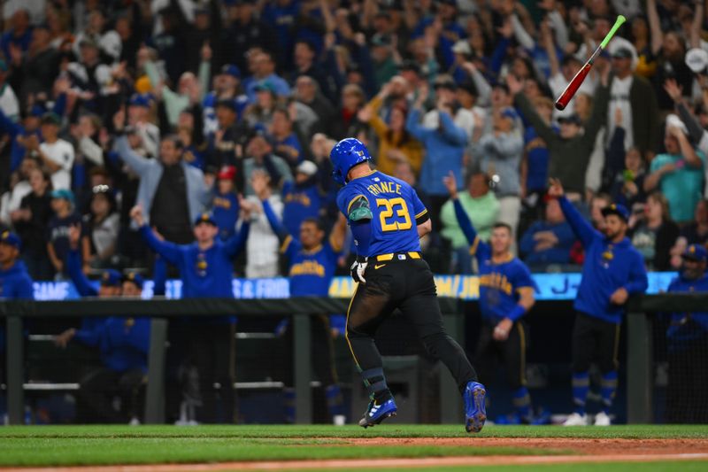 May 31, 2024; Seattle, Washington, USA; Seattle Mariners first baseman Ty France (23) tosses his bat after hitting a home run against the Los Angeles Angels during the eighth inning at T-Mobile Park. Mandatory Credit: Steven Bisig-USA TODAY Sports