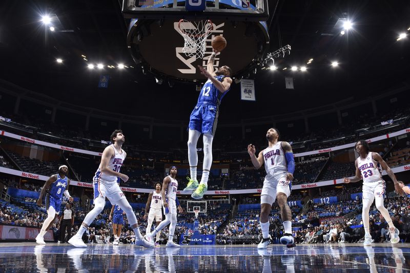 ORLANDO, FL - JANUARY 19: Trevelin Queen #12 of the Orlando Magic dunks the ball during the game against the Philadelphia 76ers on January 19, 2024 at the Kia Center in Orlando, Florida. NOTE TO USER: User expressly acknowledges and agrees that, by downloading and or using this photograph, User is consenting to the terms and conditions of the Getty Images License Agreement. Mandatory Copyright Notice: Copyright 2024 NBAE (Photo by Fernando Medina/NBAE via Getty Images)