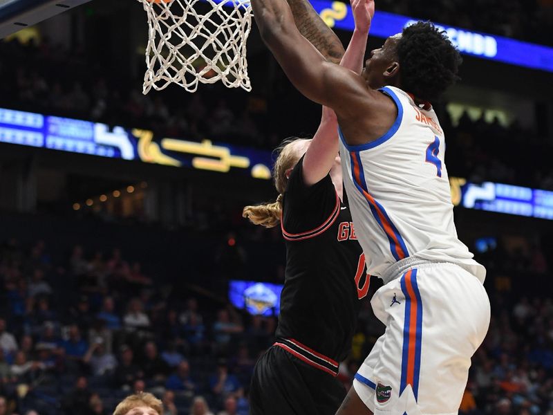 Mar 14, 2024; Nashville, TN, USA; Florida Gators forward Tyrese Samuel (4) dunks against Georgia Bulldogs guard Blue Cain (0) during the first half at Bridgestone Arena. Mandatory Credit: Christopher Hanewinckel-USA TODAY Sports