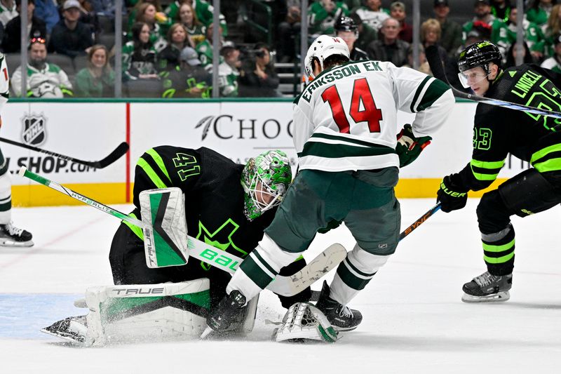 Jan 10, 2024; Dallas, Texas, USA; Dallas Stars goaltender Scott Wedgewood (41) controls the puck in front of Minnesota Wild center Joel Eriksson Ek (14) during the third period at the American Airlines Center. Mandatory Credit: Jerome Miron-USA TODAY Sports