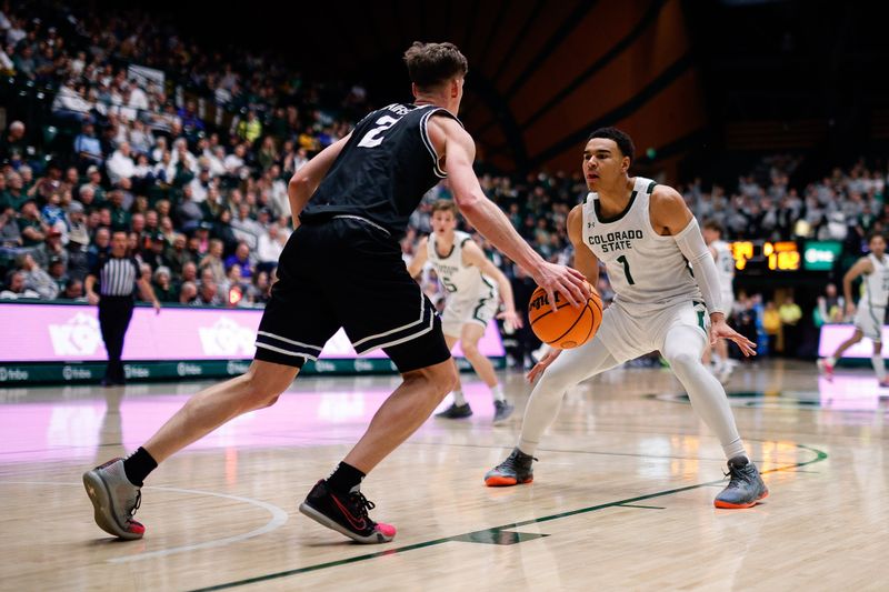 Feb 4, 2023; Fort Collins, Colorado, USA; Utah State Aggies guard Sean Bairstow (2) controls the ball as Colorado State Rams guard John Tonje (1) guards in the second half at Moby Arena. Mandatory Credit: Isaiah J. Downing-USA TODAY Sports