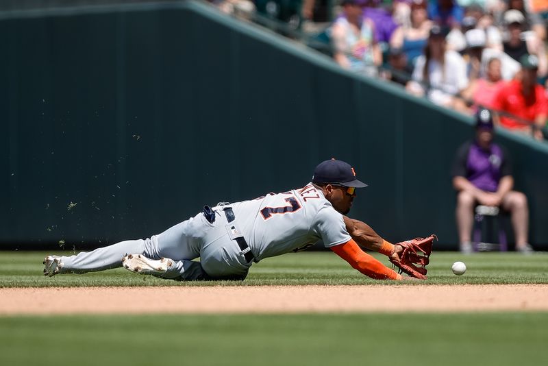 Jul 2, 2023; Denver, Colorado, USA; Detroit Tigers second baseman Andy Ibanez (77) dives for the ball in the fifth inning against the Colorado Rockies at Coors Field. Mandatory Credit: Isaiah J. Downing-USA TODAY Sports