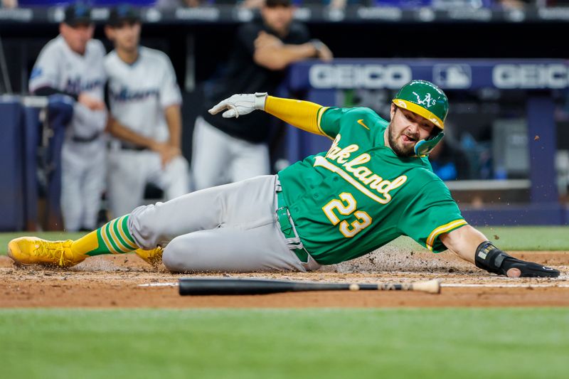 Jun 4, 2023; Miami, Florida, USA; Oakland Athletics catcher Shea Langeliers (23) scores on a RBI single from center fielder Esteury Ruiz (not pictured) against the Miami Marlins during the third inning at loanDepot Park. Mandatory Credit: Sam Navarro-USA TODAY Sports