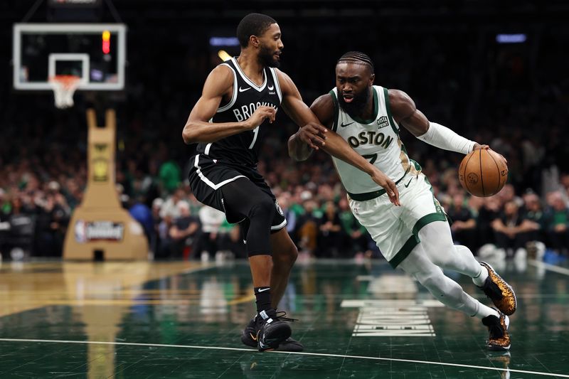 BOSTON, MASSACHUSETTS - NOVEMBER 10:  Jaylen Brown #7 of the Boston Celtics drives to the basket past Mikal Bridges #1 of the Brooklyn Nets during the first quarter of their In-Season Tournament game at TD Garden on November 10, 2023 in Boston, Massachusetts. NOTE TO USER: User expressly acknowledges and agrees that, by downloading and or using this photograph, User is consenting to the terms and conditions of the Getty Images License Agreement. (Photo by Maddie Meyer/Getty Images)